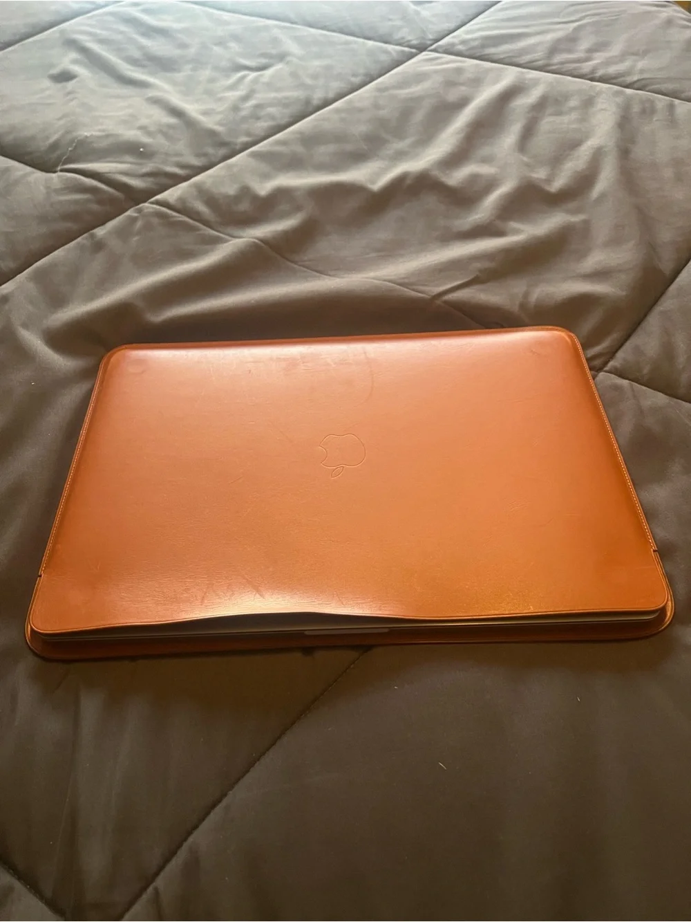 Apple Space Gray MacBook with Brown Leather Sleeve